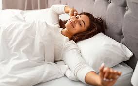 Image of a woman in bed enjoying an Improve Sleep Quality