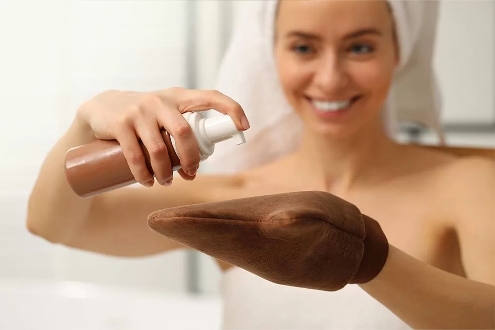 Image of a woman performing one of the Steps before applying self-tanner