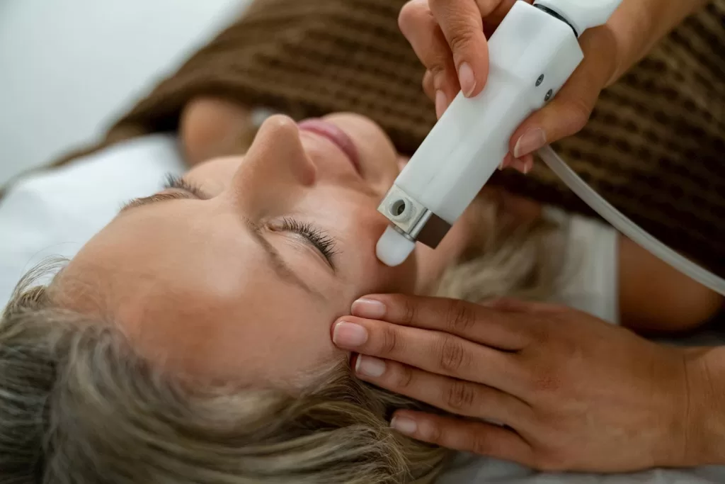 Image of a woman getting Lasers treatment done to her skin: Lasers for brown skin