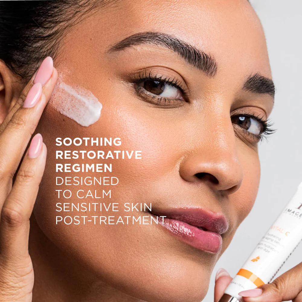 Image of a woman spreading a skincare product on her cheek. recovery skincare system